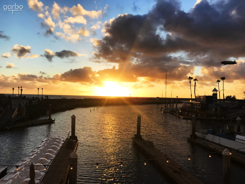 Blimp over king harbor at sunset